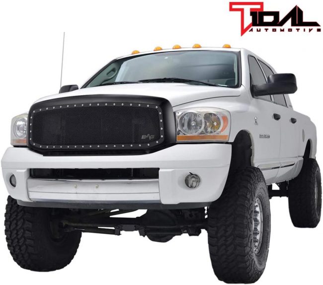 A white truck with large tires  Description automatically generated with low confidence